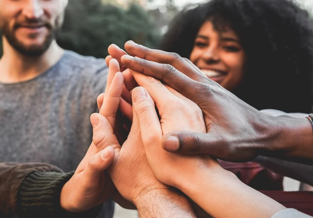 A group of friends stacking their hands together