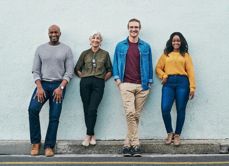 A group of church members standing together against a wall